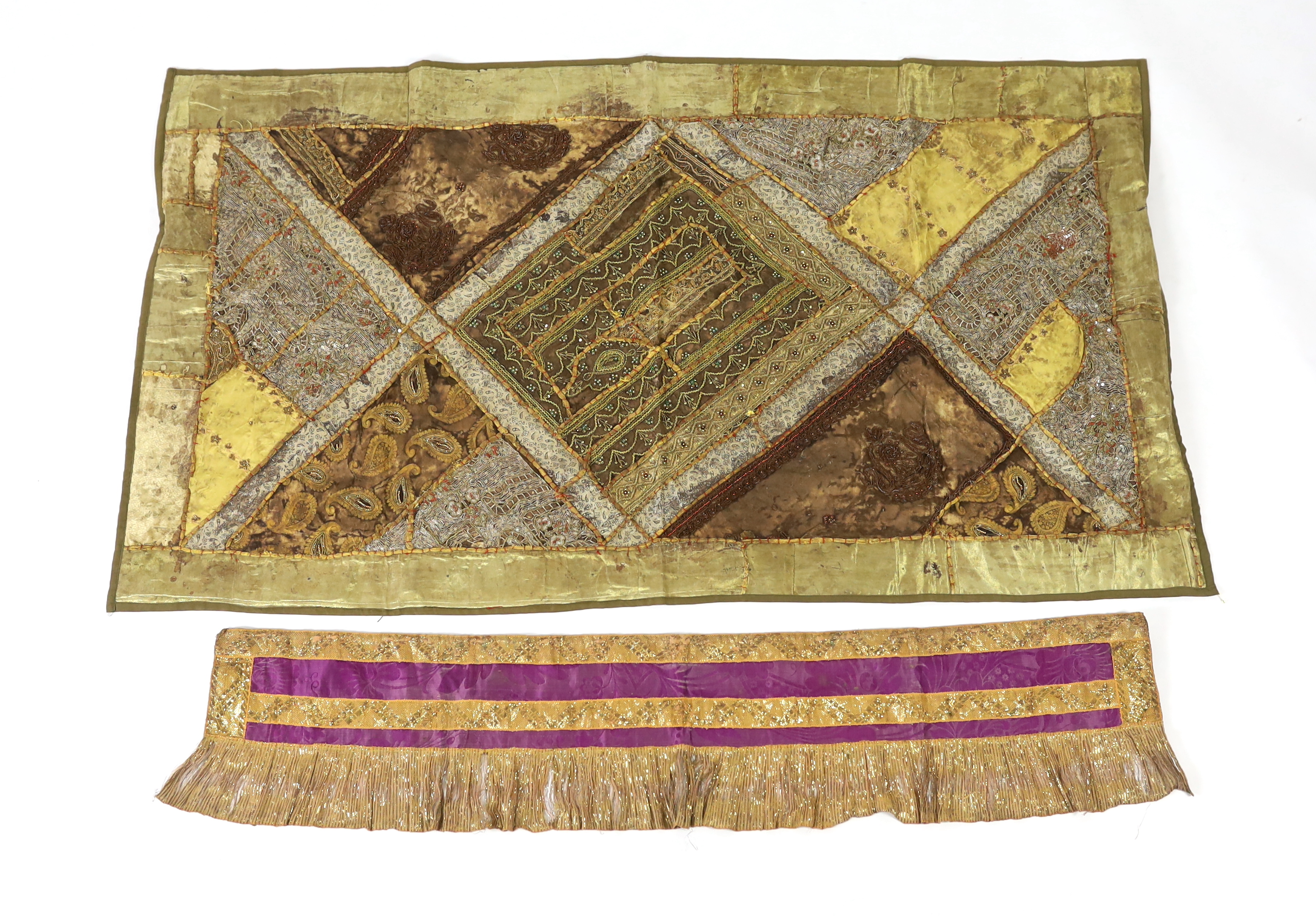 A 20th century Indian patchwork hanging, designed in golds and browns using patchwork batik, beadwork and metallic embroidery, each bordered with thick silk strands bound together, the hanging then bordered with gold met
